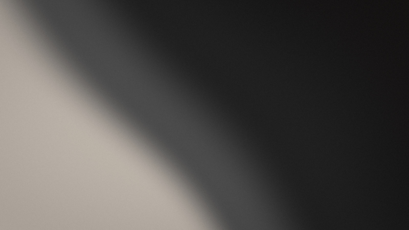 Brand artwork: a light sweep falling across black